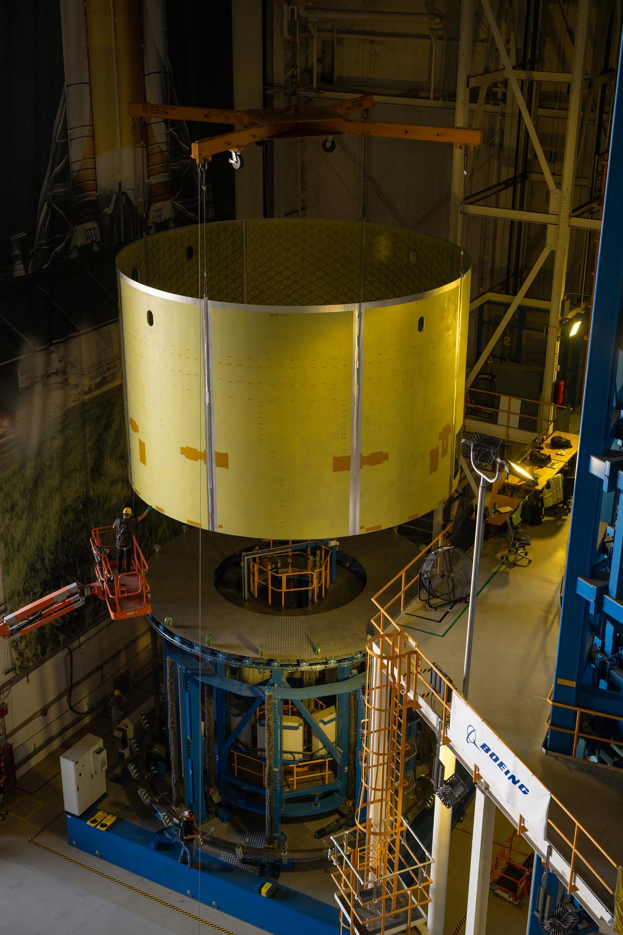 Teams at Michoud Assembly Facility in New Orleans load the engine section barrel into the vertical assembly center on Aug. 5, 2026. The engine section will be used on the SLS (Space Launch System) rocket’s core stage for the agency’s Artemis V mission. On the vertical assembly center tooling, teams will mate the flight hardware to a ring, which will serve as an attachment point for the liquid hydrogen tank later in the production process.    The engine section is one of five major elements that make up the 212-foot-tall SLS rocket stage; and houses various avionic systems, the engine thrust structure, and four RS-25 engines. The core stage produces more than two million pounds of thrust to help launch NASA’s Orion spacecraft, astronauts, and supplies beyond Earth’s orbit and to the lunar surface for Artemis.